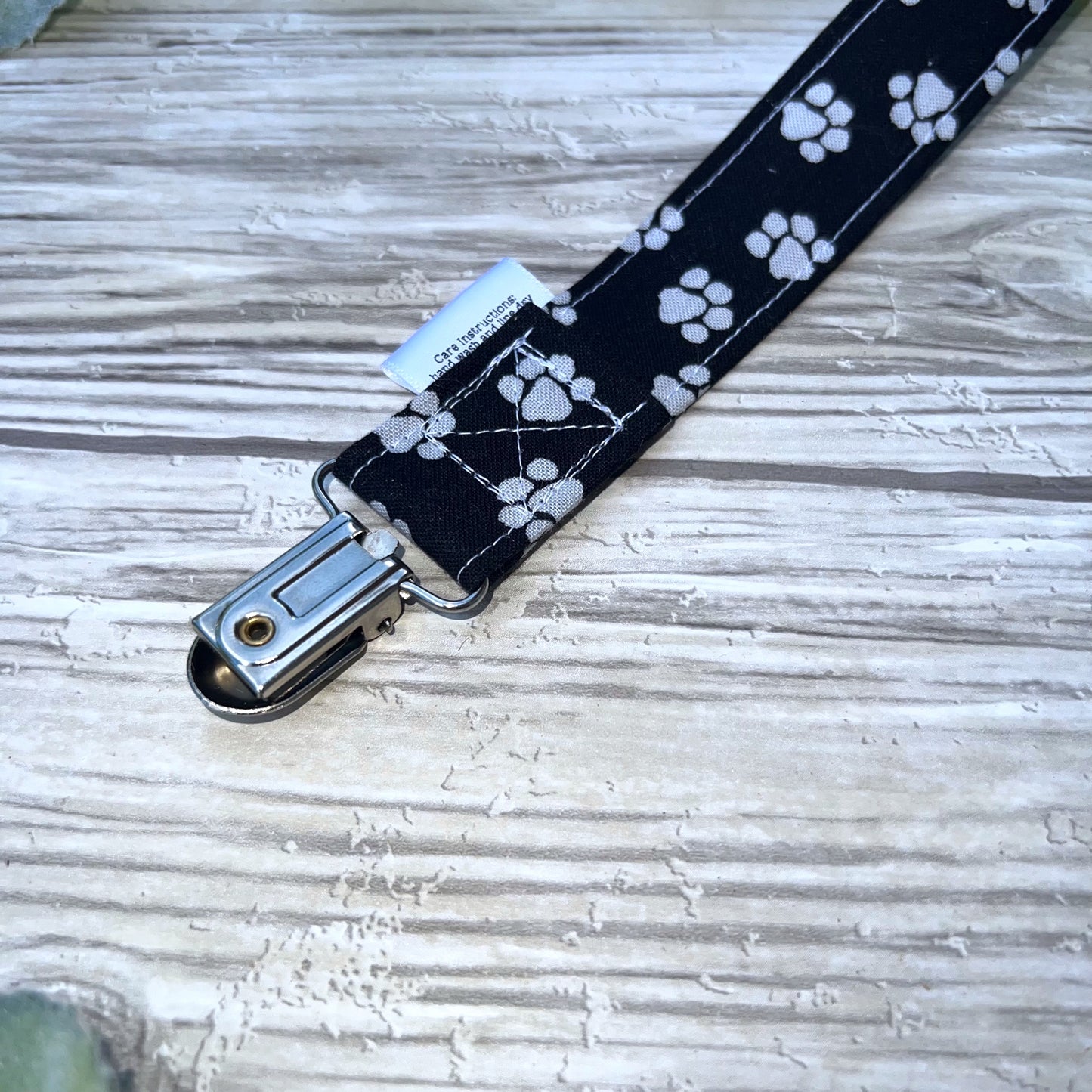 Pawprints on Black Pacifier Clip